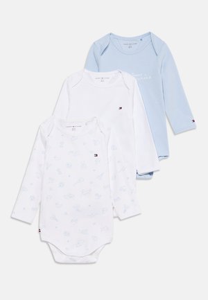 Tri detské body s dlhým rukávom v svetlomodrej, jednofarebnej bielej a bielej so svetlomodrým vzorom, všetky s malými logami Tommy Hilfiger.