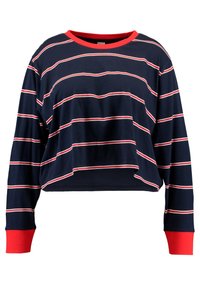 Niebieski crop top z czerwonymi akcentami i poziomymi białymi paskami. Posiada okrągły dekolt oraz długie rękawy, wykonany z miękkiej bawełny.