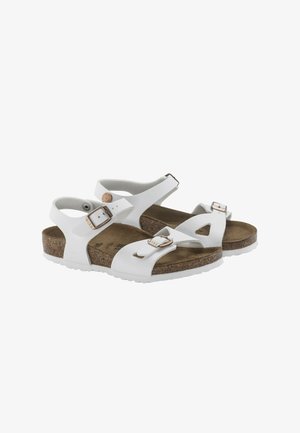 Sandali bianchi con cinturini regolabili e fibbia. Presentano una soletta in sughero e una suola in gomma. Design aperto con ritagli per favorire la traspirazione.