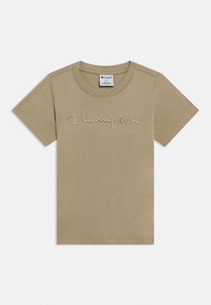 T-shirt beige à manches courtes de la marque Champion avec logo brodé sur la poitrine et col rond.