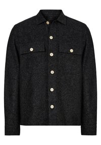 Giacca camicia nera con motivo a zig zag, realizzata in tessuto testurizzato, dotata di chiusura a bottoni, due tasche sul petto e bottoni color crema.