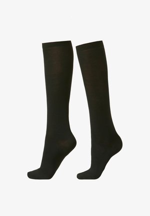 Medias negras hasta la rodilla hechas de un tejido suave, con puntera reforzada y un cómodo puño acanalado. Sin patrones ni acentos presentes.