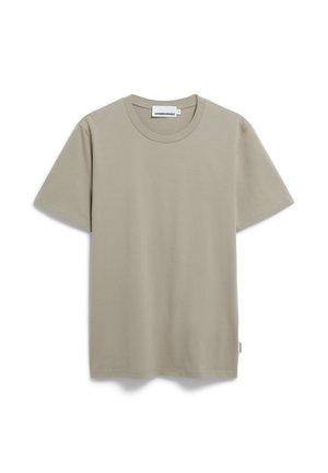 Lichtbeige katoenen t-shirt met korte mouwen, ronde hals en een eenvoudig ontwerp. Etiket aan de onderzijde toont de merknaam.