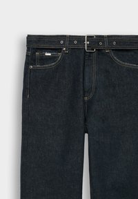 Dark denim jeans featuring a classic fit, five pockets, yellow stitching, and a metal buckle on the belt.