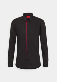 Zwarte langemouwen shirt met rode accenten langs de knoopsluiting, kraag met knopen en zwarte knopen. Gemaakt van een gladde stof.