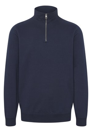 Pull léger bleu marine à zip demi, fabriqué en tissu doux, doté d'un col montant, de manches longues et de poignets et d'ourlet côtelés pour un ajustement confortable.