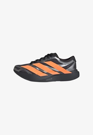 Chaussure de course noire et grise avec trois rayures orange vif sur le côté et une semelle noire épaisse étiquetée Lightstrike Pro.