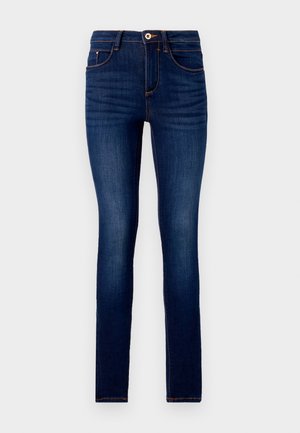 Jeans skinny em denim azul escuro, com o tradicional design de cinco bolsos, costuras laranja em contraste e um fecho de botão na cintura.