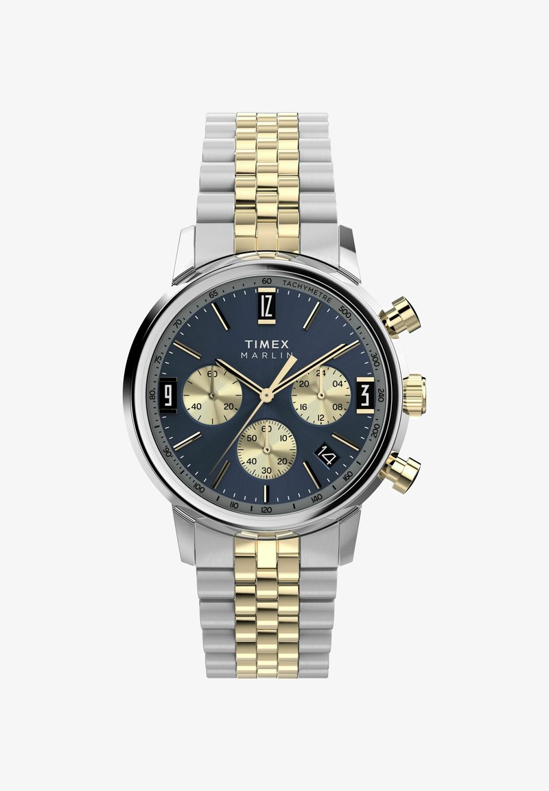 Timex Marlin kell, millel on sinine kellaplaat, hõbe- ja kuldtooniga roostevabast terasest rihm, kolm alakella ja kuupäevaaken nelja paiknemisega.