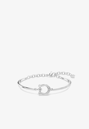 Bracelet en argent avec une chaîne délicate, présentant un design en fer à cheval orné de petits cristaux clairs sur un côté.