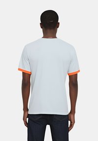 T-shirt grigio chiaro con accento arancione sulle maniche, maniche corte, collo rotondo, texture del tessuto liscia e vestibilità comoda.