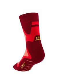 Rood en roze gemêleerde sok met een gestructureerd breipatroon. Heeft opvallende gele accenten en een strakke boord aan de bovenkant. Gemaakt van ademend materiaal.