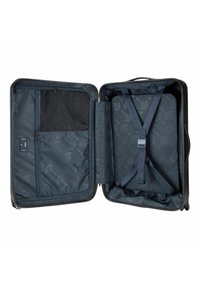 Schwarzer Koffer mit Reißverschlussöffnung, ausgestattet mit marineblauem Innenfutter, Netzfach und verstellbaren Gurten. Durchgehend mit Blumenmuster.