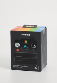Polaroid Now+ instant camera packaging in black with a color stripe design. Features round lens, buttons, and app control icon on the side.