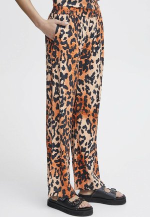 Pantaloni a gamba larga con stampa leopardata in arancione e nero, realizzati in tessuto morbido, con vita elastica e tasche laterali.
