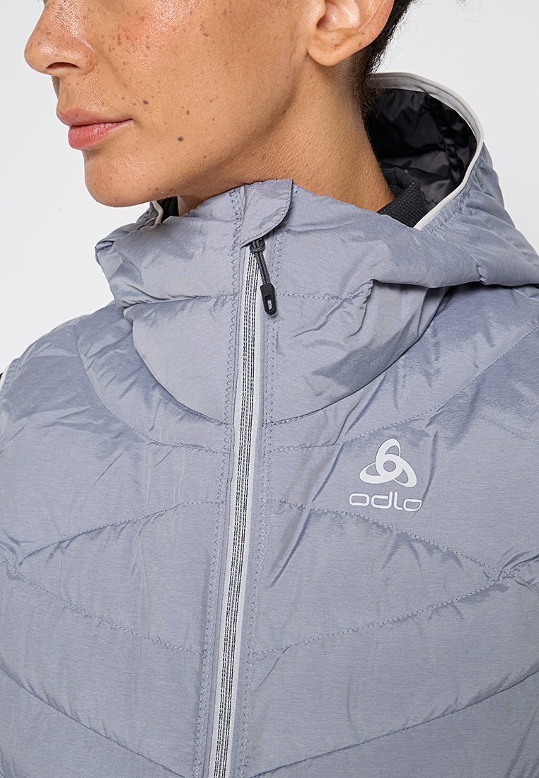 Grau gepolsterte Jacke mit durchgehendem Reißverschluss und Kapuze. Verfügt über ein geometrisches Steppmuster und ein Logo auf der Brust, mit einer glatten Textur.