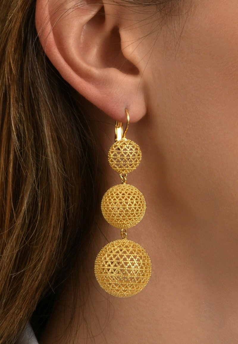 Boucles d'oreilles en or comportant trois éléments sphériques avec des motifs tissés complexes de taille décroissante, suspendues à un crochet simple.