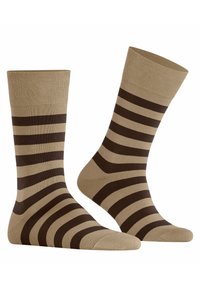 Beige Socken mit dunkelbraunen Streifen, die eine glatte Textur und eine Standardlänge haben. Gefertigt aus einem weichen, dehnbaren Material.