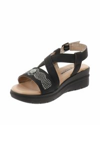 Sandal nero con cinturini incrociati e chiusura alla caviglia regolabile. Presenta una soletta imbottita e strass decorativi sulla parte superiore. Suola a zeppa.