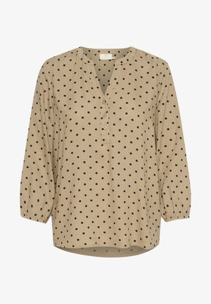Bluză bej cu buline, cu decolteu în V, închidere cu nasturi și mâneci lungi puff. Țesătura are un finisaj texturat cu modele circulare negre.