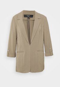 Beige Blazer mit Revers, zwei Fronttaschen und hochgerollten Ärmeln, die mit Druckknöpfen befestigt sind. Hergestellt aus weichem, strukturiertem Stoff.