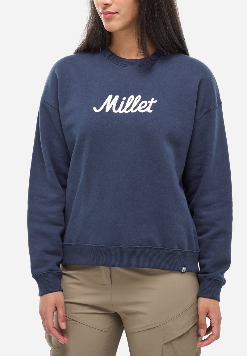 Sweatshirt bleu marine en coton, avec un col rond et des poignets côtelés. "Millet" brodé en blanc sur la poitrine.
