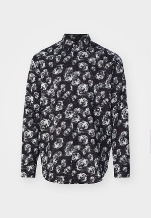 Chemise noire à manches longues avec un motif de roses blanches, col et fermeture à boutons. Fabriquée en tissu léger avec une texture douce.