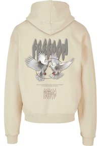 Creme hoodie med grafik af to hvide duer, ordet "FRIHED" i stiliseret grå skrift ovenfor, samt ribbet kant og manchetter.