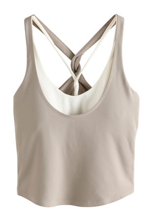 Beige sleeveless crop top with deep scoop neckline and crossed thin white straps at the back.