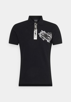 Polo noir en coton, avec un motif graphique blanc sur le devant, col côtelé et manches courtes.