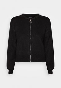 Czarny dziergany kardigan z okrągłym dekoltem, przednim zamkiem błyskawicznym i prążkowanymi mankietami. Miękka tekstura i skrócony fason z akcentem ze srebrnym okuciem.