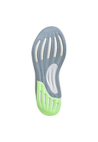 Shoe outsole with a gray upper, white accents, and a green section. Features unique tread patterns and multiple grooves for traction.