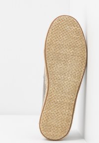 Chaussure en tissu gris avec une semelle beige tissée texturée, présentant un bord net et un design minimaliste. Convient pour un usage décontracté.