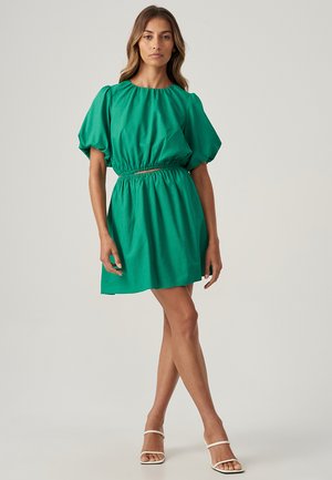 Green short dress with a round neckline, puffed sleeves, and an elastic waist. Made from lightweight fabric, it falls above the knees.