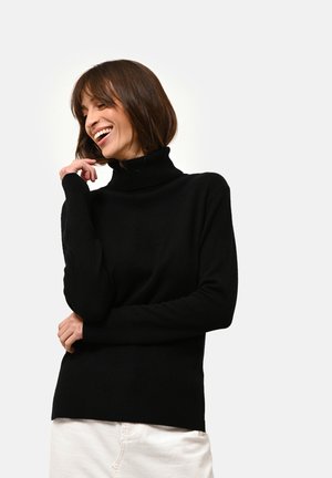 Maglione a collo alto nero realizzato in morbido tessuto knit, con polsini e orlo a coste, dal fit rilassato e senza decorazioni.