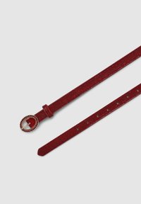 Cintura in tessuto rosso con finitura testurizzata, fibbia in metallo dorato con dettagli in pietra rossa e vari fori per la regolazione lungo la cinghia.