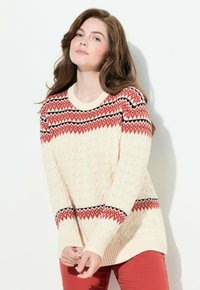 Maglione lavorato a maglia crema con un motivo geometrico rosso e nero sul petto, con polsini e orlo a costine. Elegante, vestibilità rilassata.