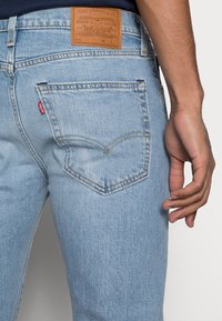 Levi's® SKINNY TAPER - Calças de ganga de corte skinny - corfu lucky day