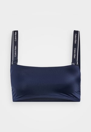 Navy blue bralette with a smooth texture, featuring wide straps with Calvin Klein logo and a simple, minimalist design.