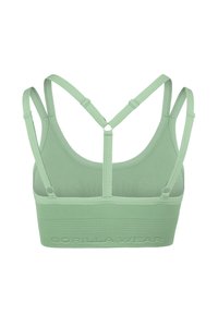 Groene sportbeha met een geribde band, voorzien van verstelbare bandjes en een kruisontwerp aan de achterkant. Zacht, rekbaar materiaal.