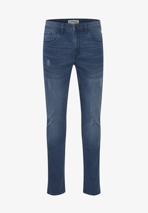 Skinny jeans made of dark blue denim, featuring a slightly faded finish and distressed detailing on the front. Classic five-pocket design.