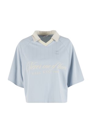 Világoskék, rövid fazonú mez függőleges tűcsíkozással, bézs gallérral, és hímzett felirattal: "Never one of them" a "KARL KANI 1989" logóval.