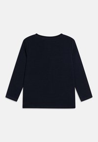 Long-sleeve shirt in dark navy cotton. Crew neckline, simple design with no embellishments. Soft texture, straight hem, and fitted sleeves.