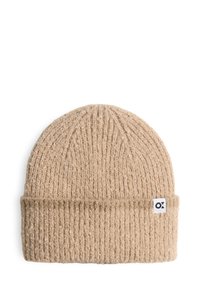 Knit beige beanie with ribbed texture, folded cuff, and small white label with black logo on the side. Soft material.