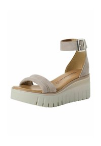 Sandalo wedge in suede beige con cinturino alla caviglia, una larga fascia frontale e suola piatta texture. Dotato di fibbia in metallo e plantare imbottito.