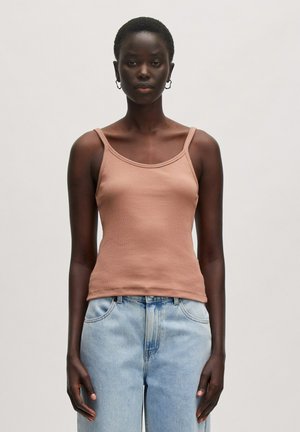 Bruine geribde tanktop met dunne bandjes, met een ronde halslijn en een fitted silhouet. Gekenmerkt door lichtblauwe high-waisted jeans.