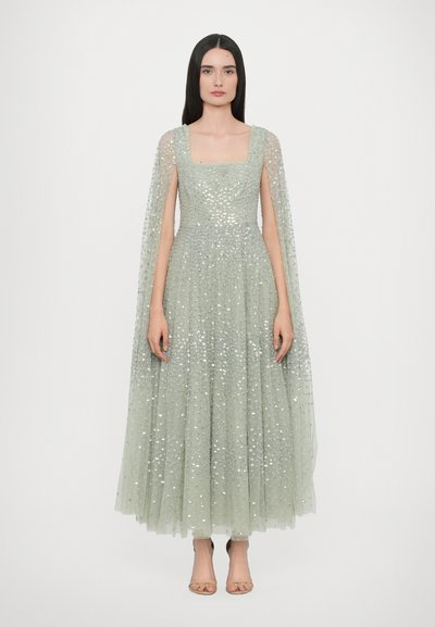 Long, light green dress made of layered tulle, featuring a square neckline, sequined embellishments, and sheer, flowing cape sleeves.