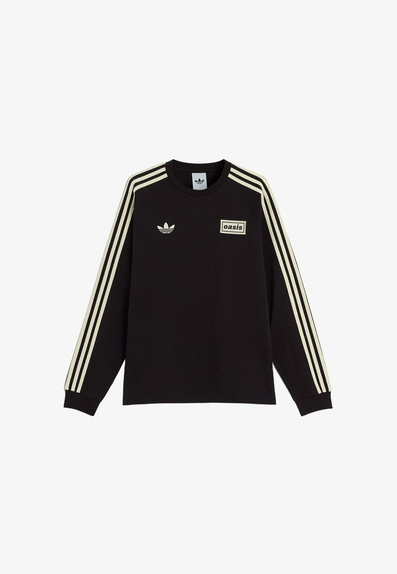 Black sweatshirt with long sleeves, cream stripes along the shoulders, and a rectangular "oasis" label on the front. Features a logo on the chest.