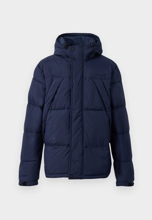 Marineblauwe pufferjack met een capuchon, voorzien van grote doorgestikte secties, drukknopen aan de voorkant en elastische manchetten voor een comfortabele pasvorm.