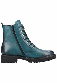 Bottes basses en cuir bleu sarcelle avec un bout arrondi, des lacets à l'avant et une fermeture éclair latérale. Semelle noire épaisse avec des crampons pour la traction et l'adhérence.